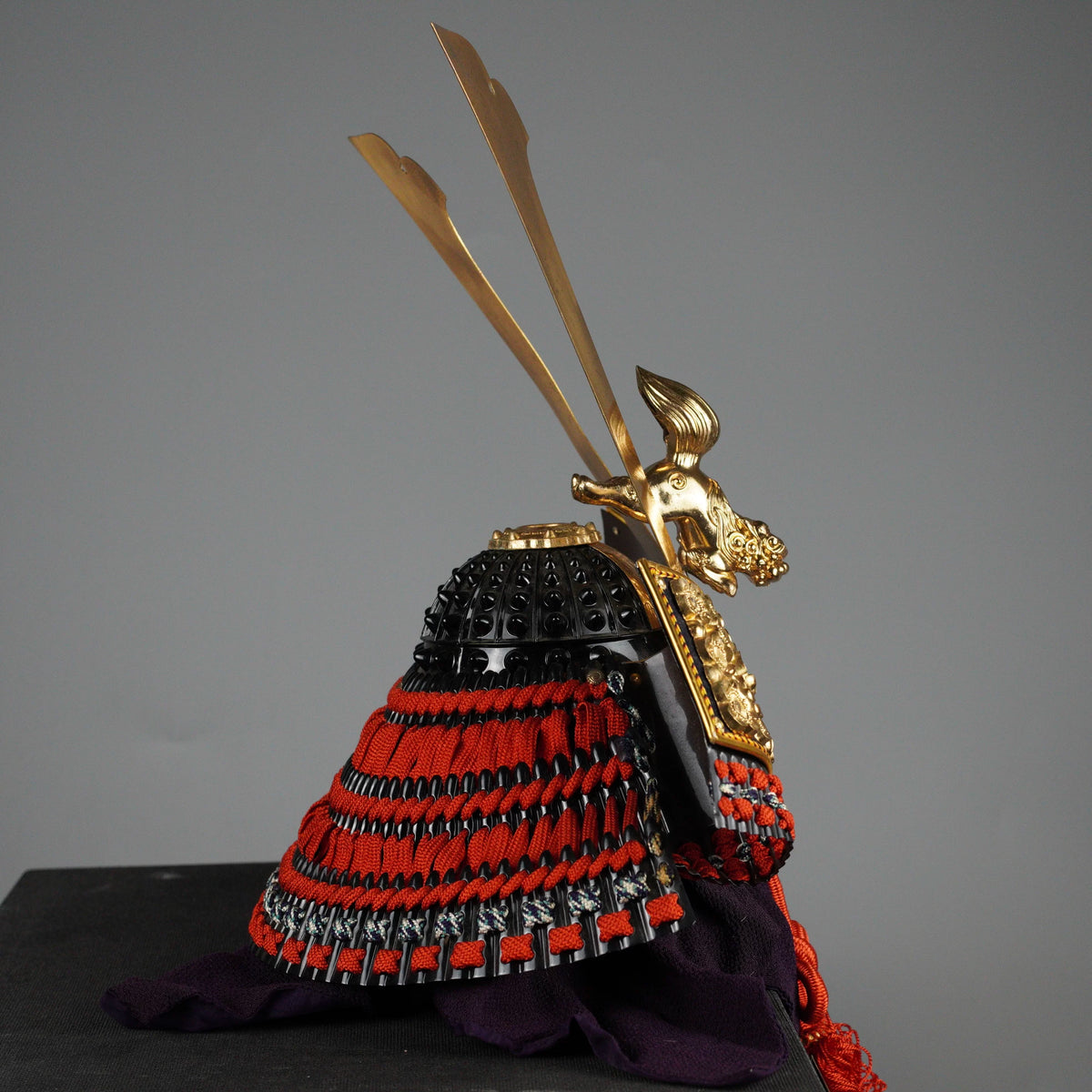Kabuto helmet on lacquered box stand with wooden nameplate