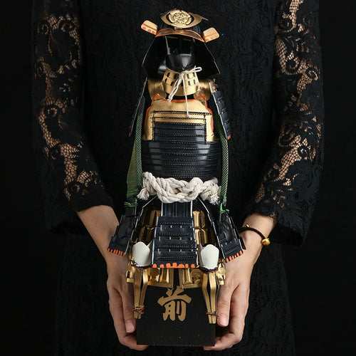 Scaled samurai armor figure on wooden stand, three-quarter view